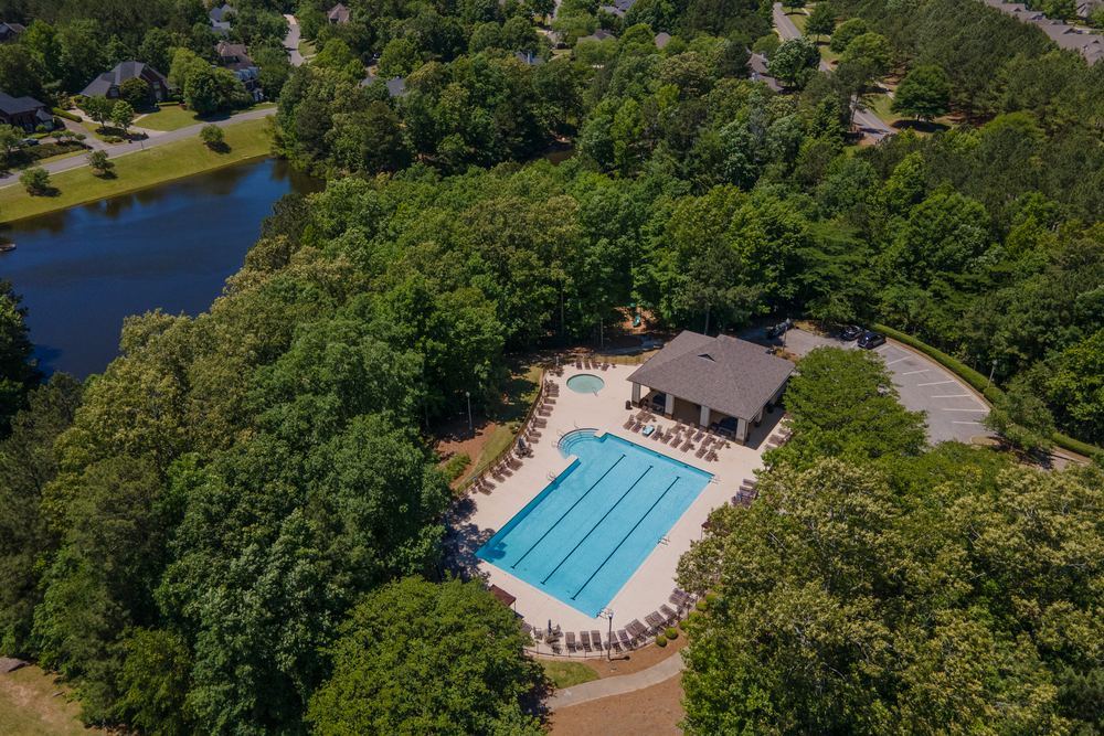 Aerial view of a neighborhood pool surrounded by trees
