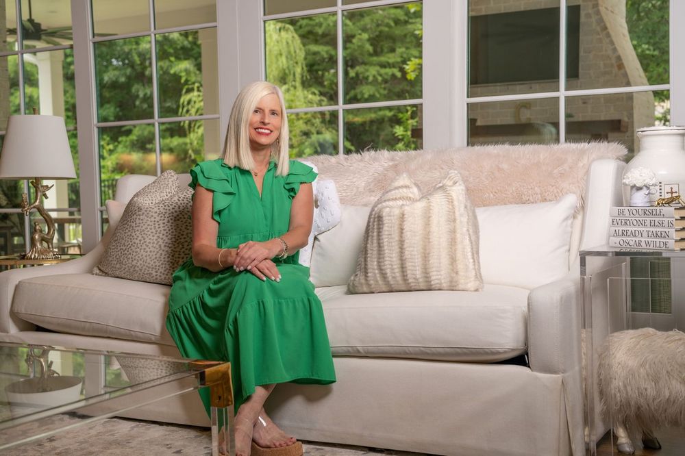 Michelle Creamer seated on a sofa in a bright sitting room